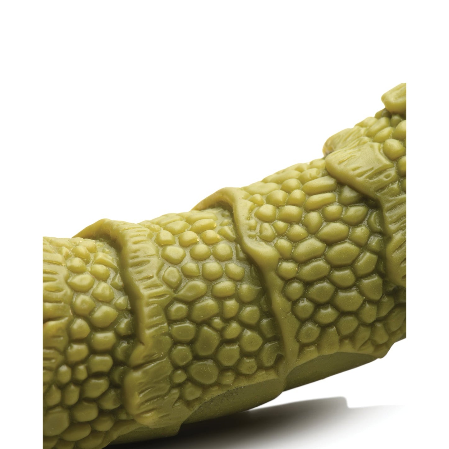 A close-up of the Creature Cocks Swamp Monster Scaly Silicone Dildo in green, featuring a textured surface with a scaly pattern and hexagonal shapes, against a white background.