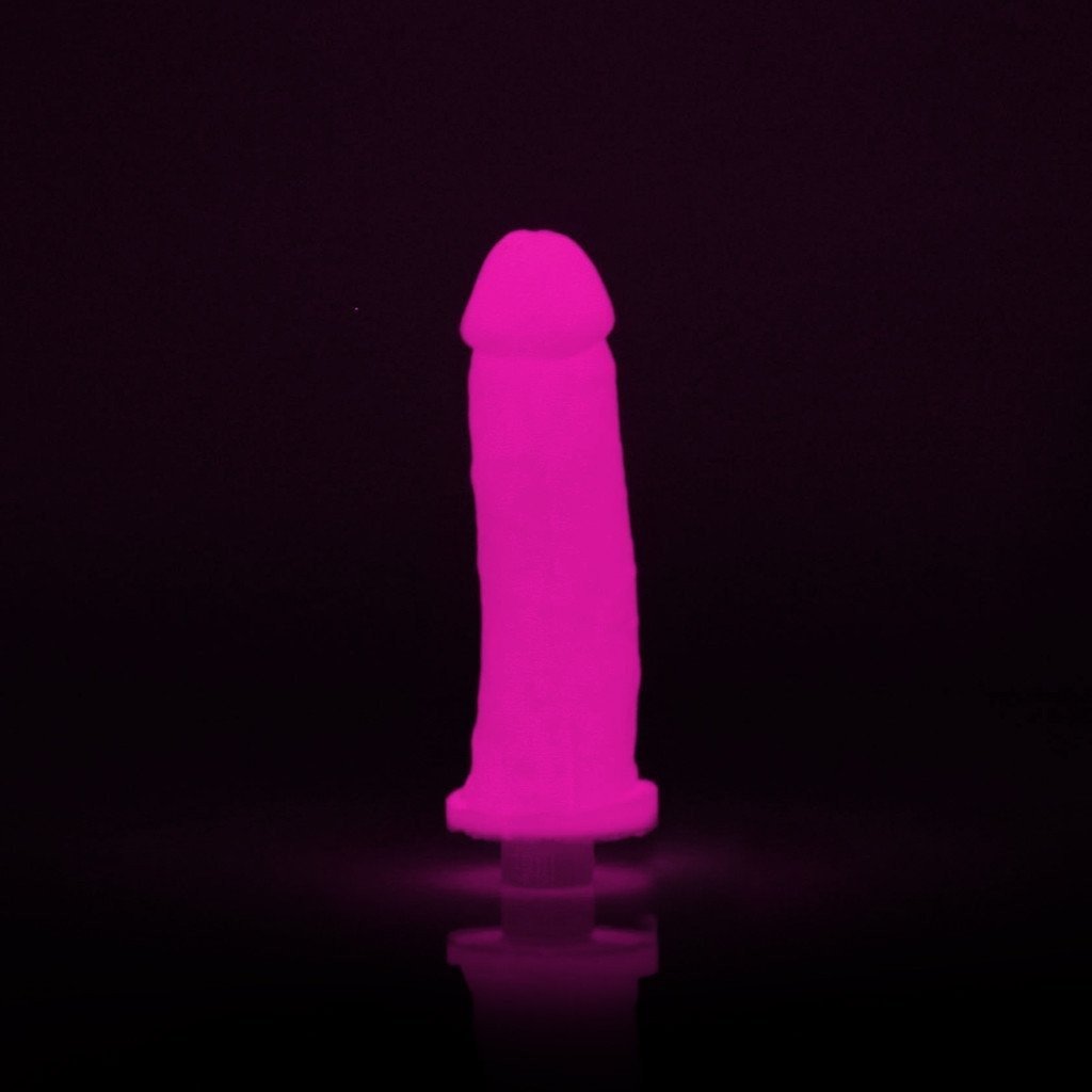 The Empire Labs Clone-A-Willy Kit - Vibrating includes a pink glow-in-the-dark condom, showcased elegantly upright against a black background.