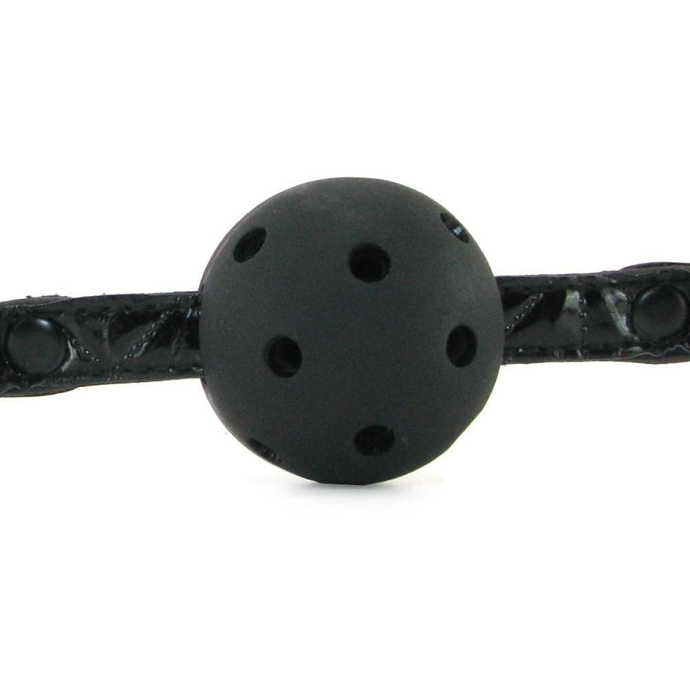 The NS Novelties Sinful Ball Gag features a black neoprene ball with holes, centered in the image, and attached to an adjustable black strap for comfort and style.