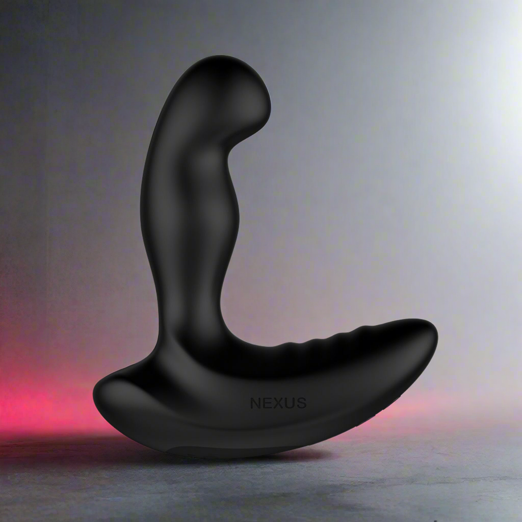 The Nexus Ride Prostate Massager is a black, curved massager with a vibrating shaft and ergonomic textured design, standing upright against a gradient background that shifts from red on the left to gray on the right, with NEXUS engraved on its base.