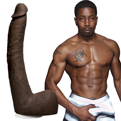 A tattooed, shirtless Isiah Maxwell poses confidently next to Doc Johnsons Signature Cocks ULTRASKYN 10 Cock. The lifelike, cylindrical, and textured dildo stands on display, creating a striking juxtaposition.