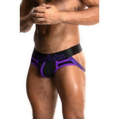 A muscular man models the *ssTricks Juku Jock in Black Venom, with a thick waistband and exposed hips and thighs, set against a plain white background.
