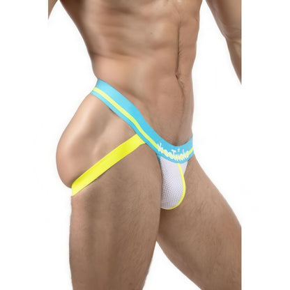 A fit male model wears the *ssTricks Jockstrap in Twisted Teal, featuring blue, yellow, and white bands and a supportive mesh pouch, shown close-up from the side against a clean white background.