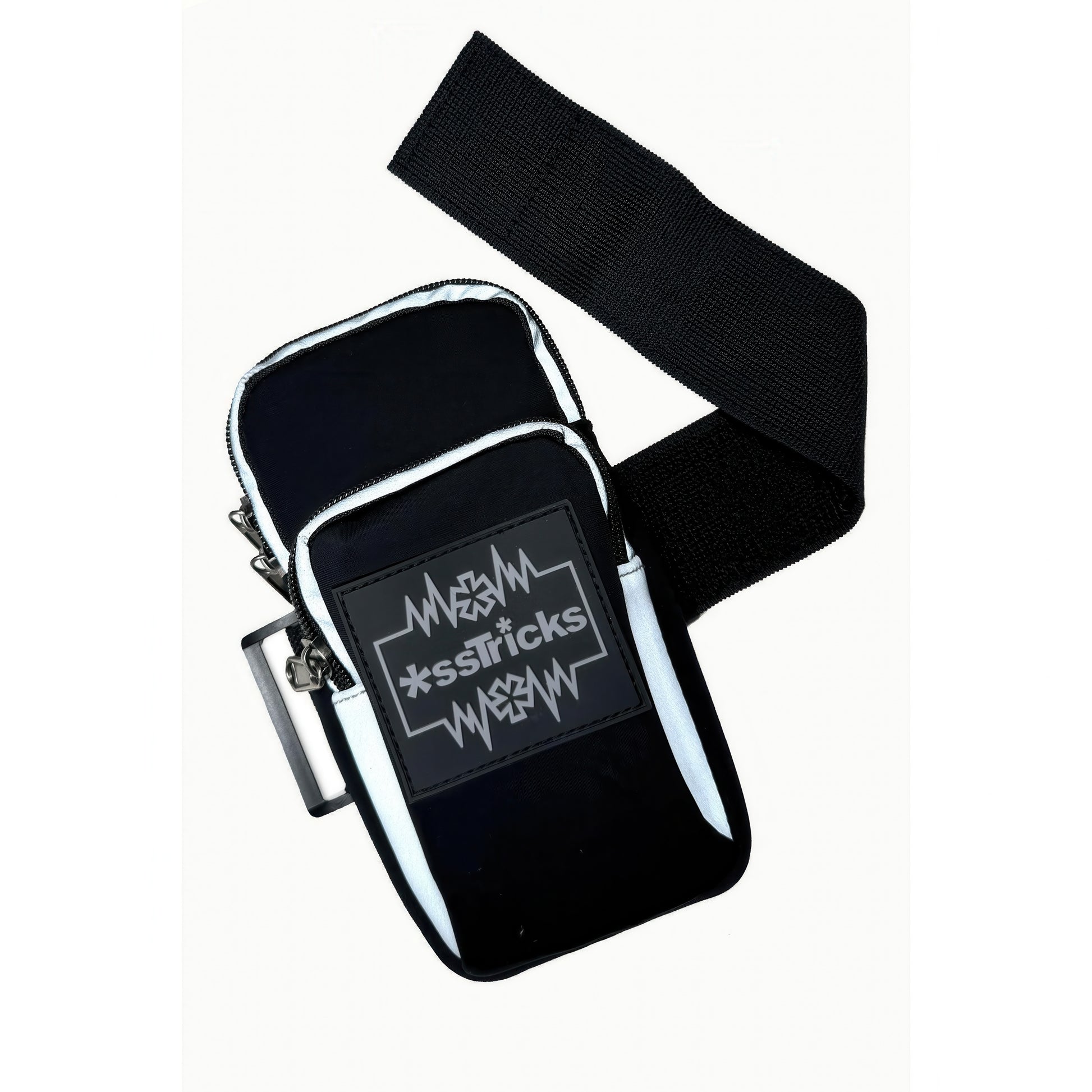 The EKG Arm Bag in Black by *ssTricks is a small, water-resistant neoprene bag with a wide black strap. It features a front rectangular patch with white jagged lines and stylized *ssTricks text for everyday protection.