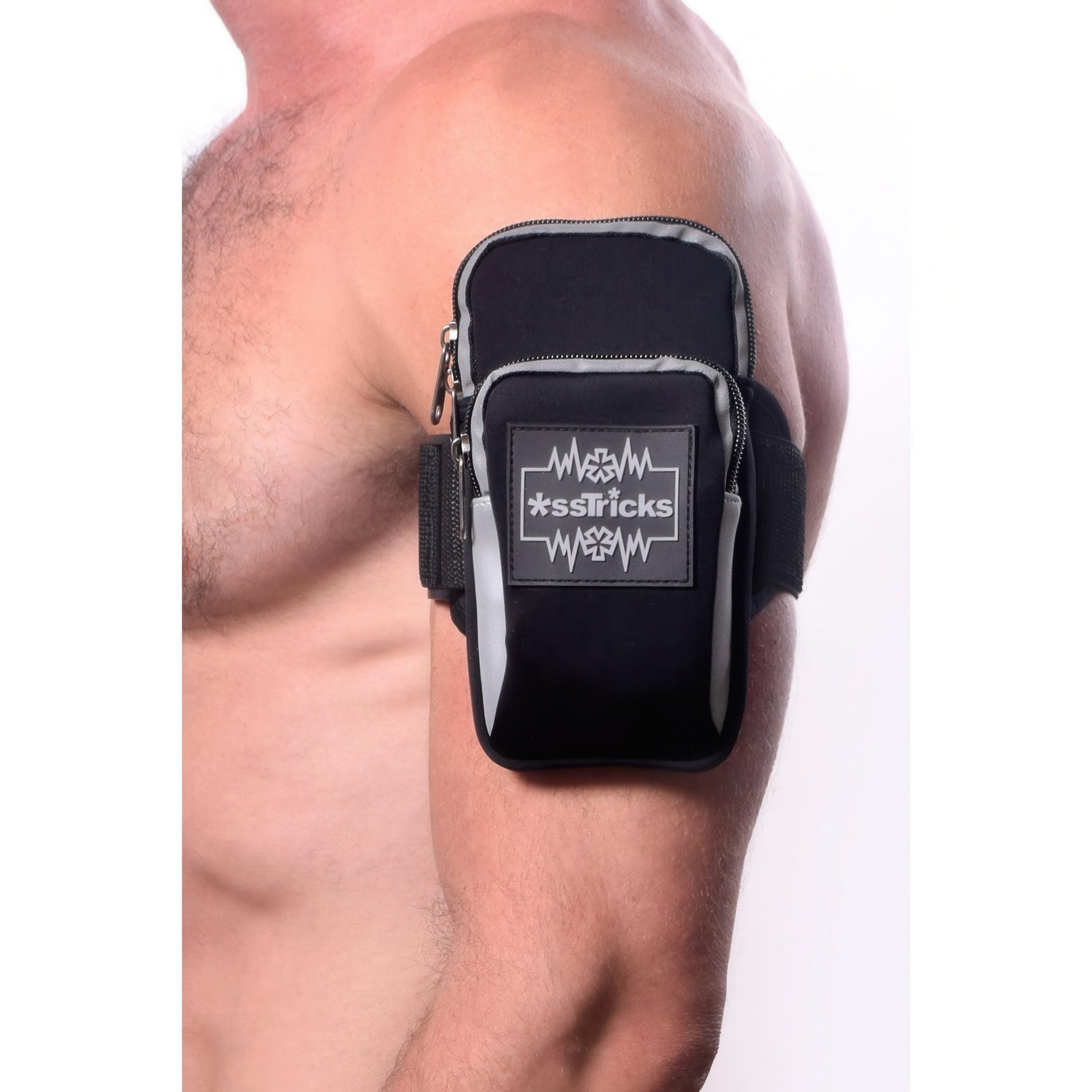 A shirtless person wears the EKG Arm Bag in Black by *ssTricks, an adjustable, water-resistant neoprene pouch with a zipper and reflective patch on their upper arm, ideal for carrying small items during exercise.
