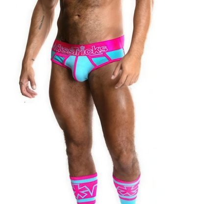 A model showcases *ssTricks mens Cotton Candy Pocket Briefs and knee-high socks. The briefs, in pink and aqua, feature Nasty Tricks on the waistband, while the socks display a geometric pattern in cotton candy colors. This vibrant set stands out against a crisp white backdrop.