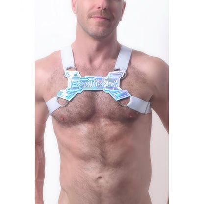 A man models the *ssTricks Transistor Harness in White, featuring thick white straps and metallic accents that expose his chest and shoulders, set against a plain white background.