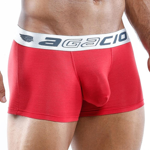 A person wearing Agacio Boxer Trunk in red with a white waistband featuring black text. The photo highlights the silky smooth fabric and contouring pouch, enhancing the underwears fit and style.