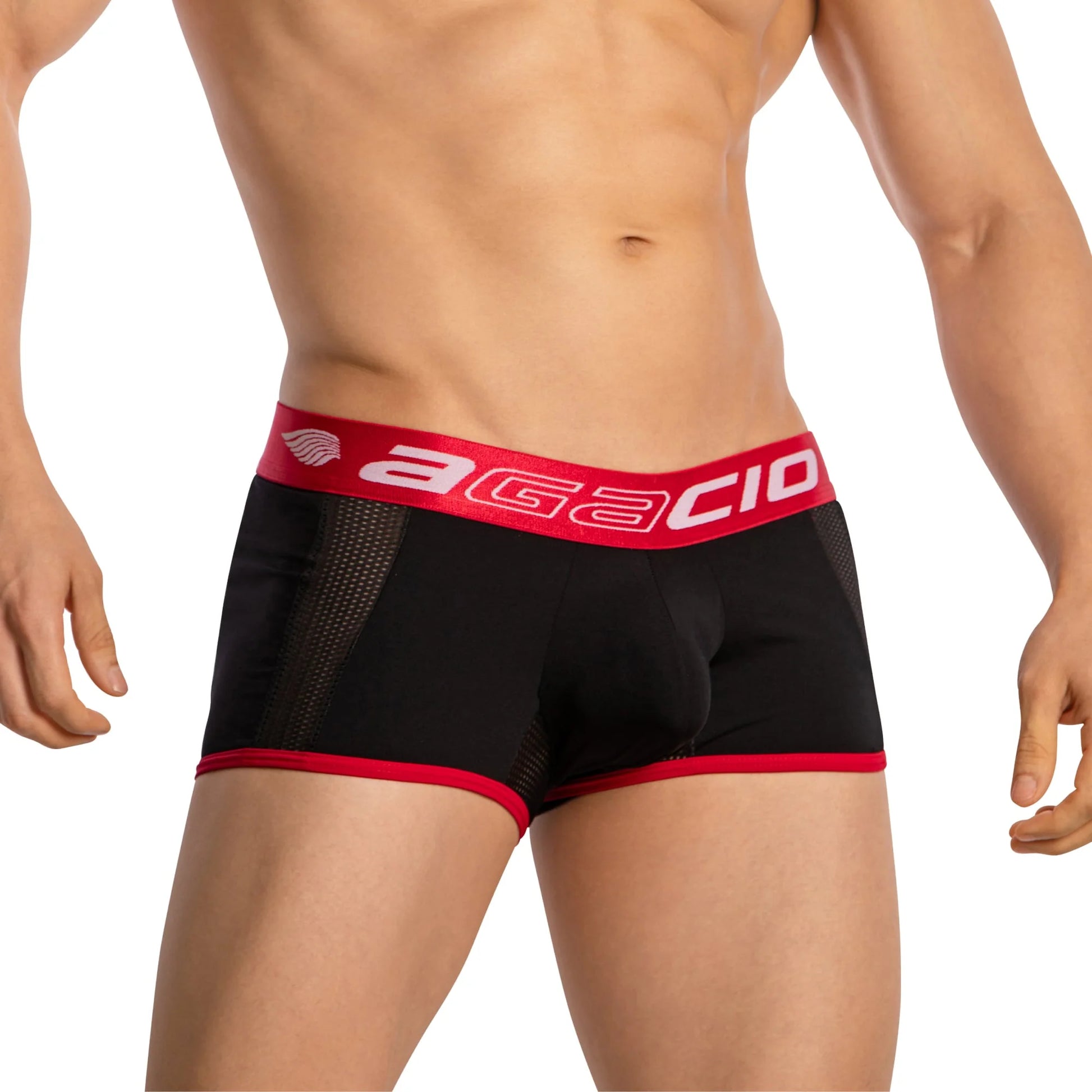Sporting Agacio Boxer Sheer Trunks with contoured support, a person wears trunks featuring a red waistband and trim that boldly display the Agacio brand in white. Their torso and upper legs are visible against a plain backdrop.