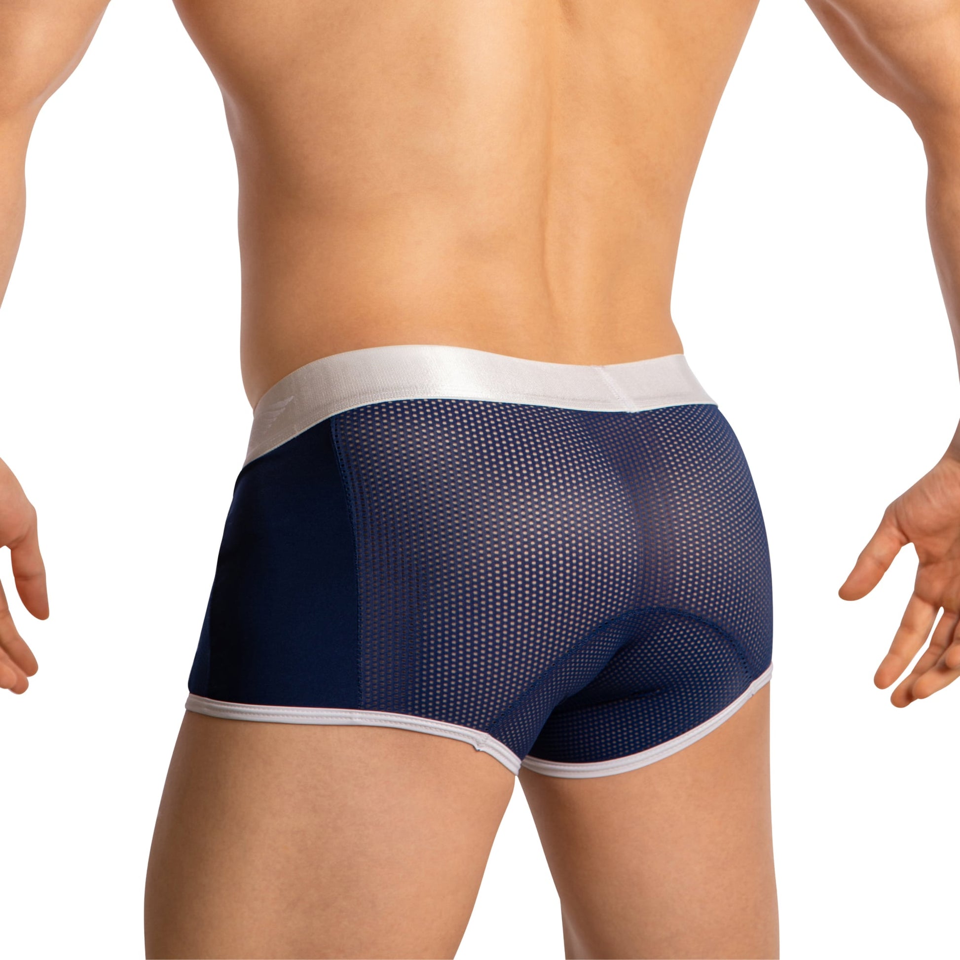 The Agacio Boxer Sheer Trunks in dark blue feature a sheer mesh fabric, accented by a white waistband and trim. The design emphasizes contoured support and style on the hips and lower back.