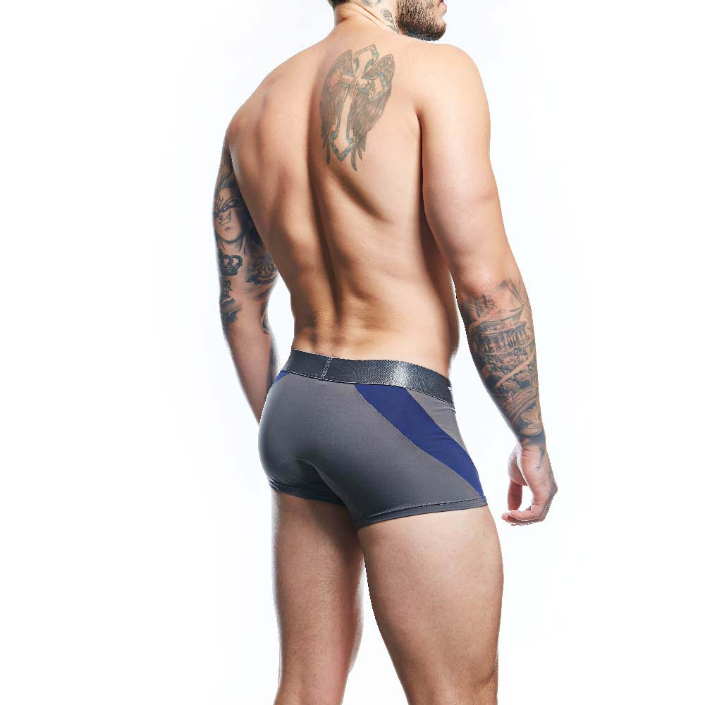 A tattooed man poses against a white background, showcasing his back and left side. He wears Agacio Boxer Trunks Comfortable Underwear, highlighting a large wing tattoo on his upper back and various tattoos along his arm with contour pouch magic for comfort.