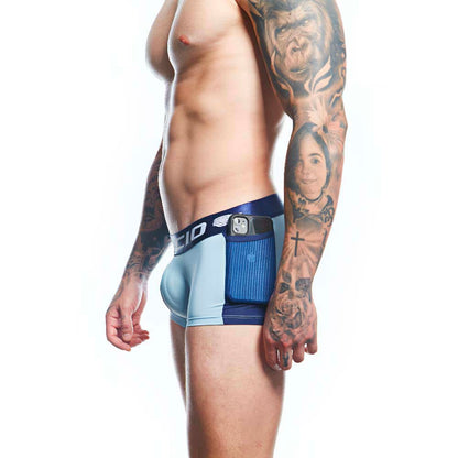 A tattooed person poses in profile, highlighting the comfort and support of Agacio Boxer Trunks Comfortable Underwear. An electronic device decorates the waistband against a plain white backdrop.