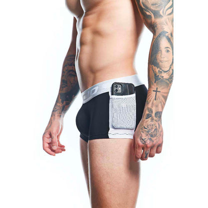 A tattooed man wearing Agacio Boxer Trunks Comfortable Underwear in black and white showcases their comfort and support, with a side pocket holding a smartphone. The image highlights his torso and upper legs, emphasizing both design and functionality.