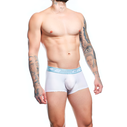 A shirtless, tattooed man confidently poses against a white backdrop, showcasing Agacio Boxer Trunks Comfortable Underwear that provide unparalleled support and comfort.