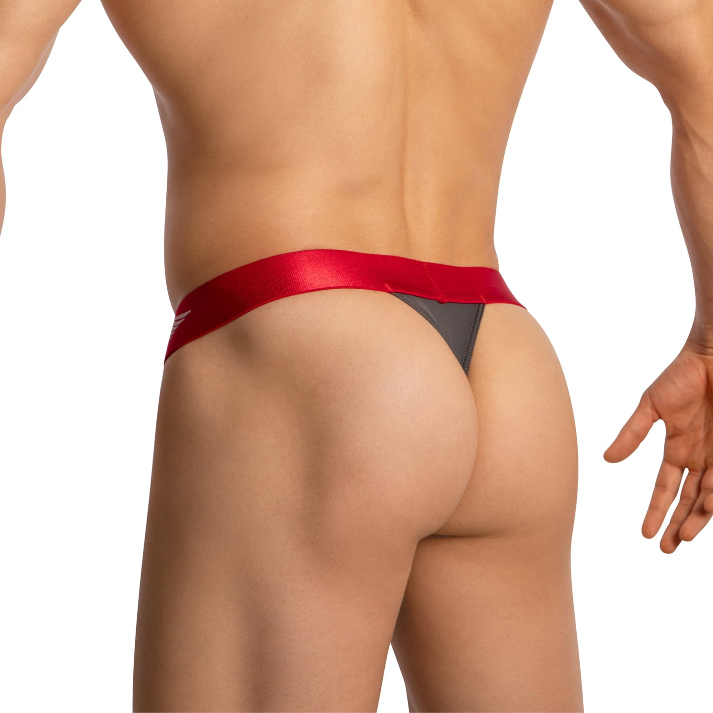 The image shows the back view of a person in Agacio V-Cut Sheer Mens Thongs, highlighting its red and black minimal coverage fit. They are slightly turned to the side against a plain white background, creating a striking contrast that emphasizes the products design by Agacio.