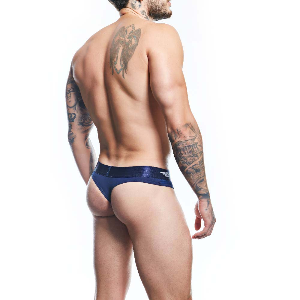 A tattooed man is seen from the back wearing Agacios navy blue Thong for Men, crafted from a premium fabric blend. He stands against a plain white background, highlighting the minimalist design and detailed tattoos on his arms and back.