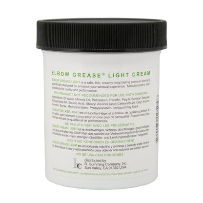 The Elbow Grease Light Cream, in a white jar, promises a silky glide and is aimed at enhancing sensual experiences. It contains mineral oil, so do not use with condoms. Company details and distribution address are listed at the bottom.