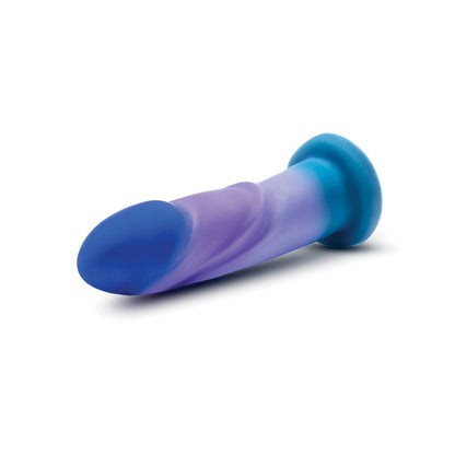 The Blush Avant Midnight Rendezvous Silicone Dildo by Blush Novelties showcases a smooth, curved design with blue and purple hues and a sturdy, flared suction base for stability.