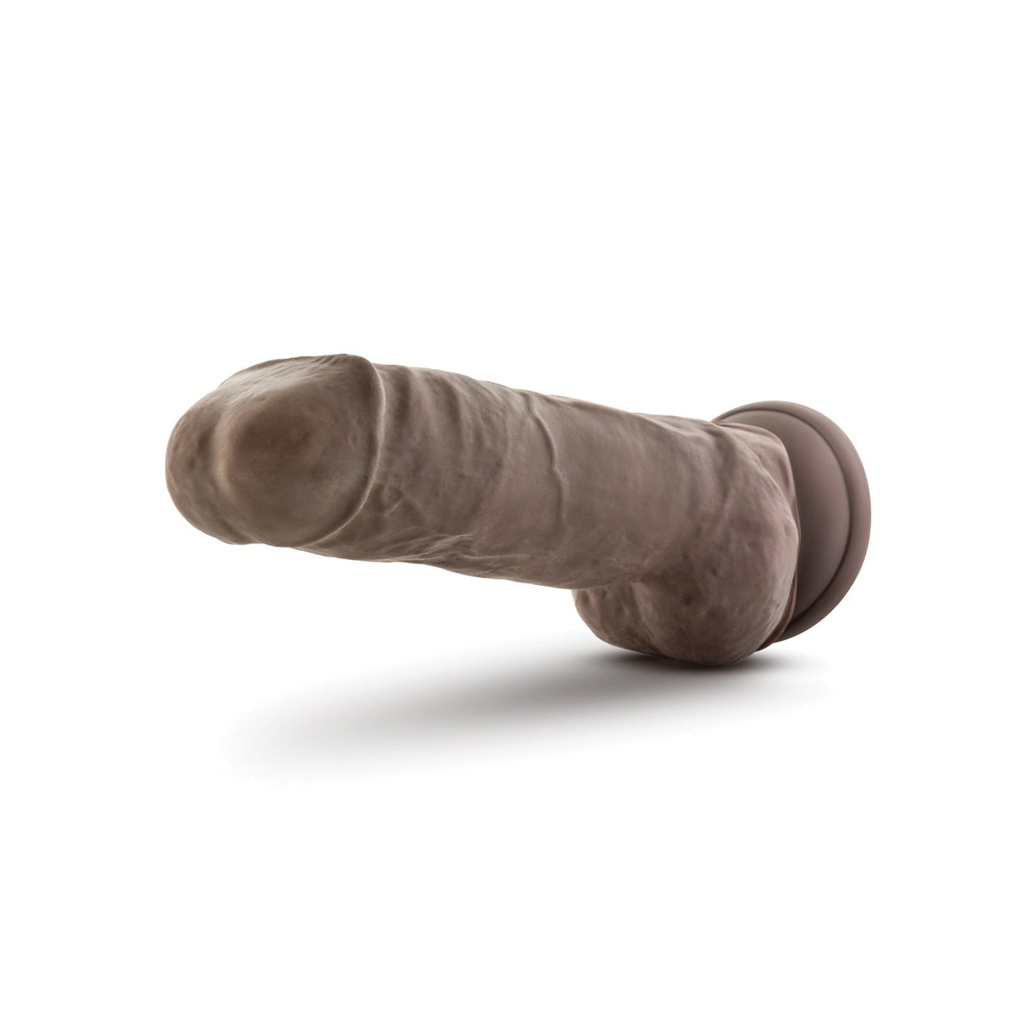 The Blush Au Naturel 10 Big Boy Realistic Dildo by Blush Novelties, a lifelike brown silicone dildo with dual density and a flared suction cup base, is positioned horizontally against a white background.