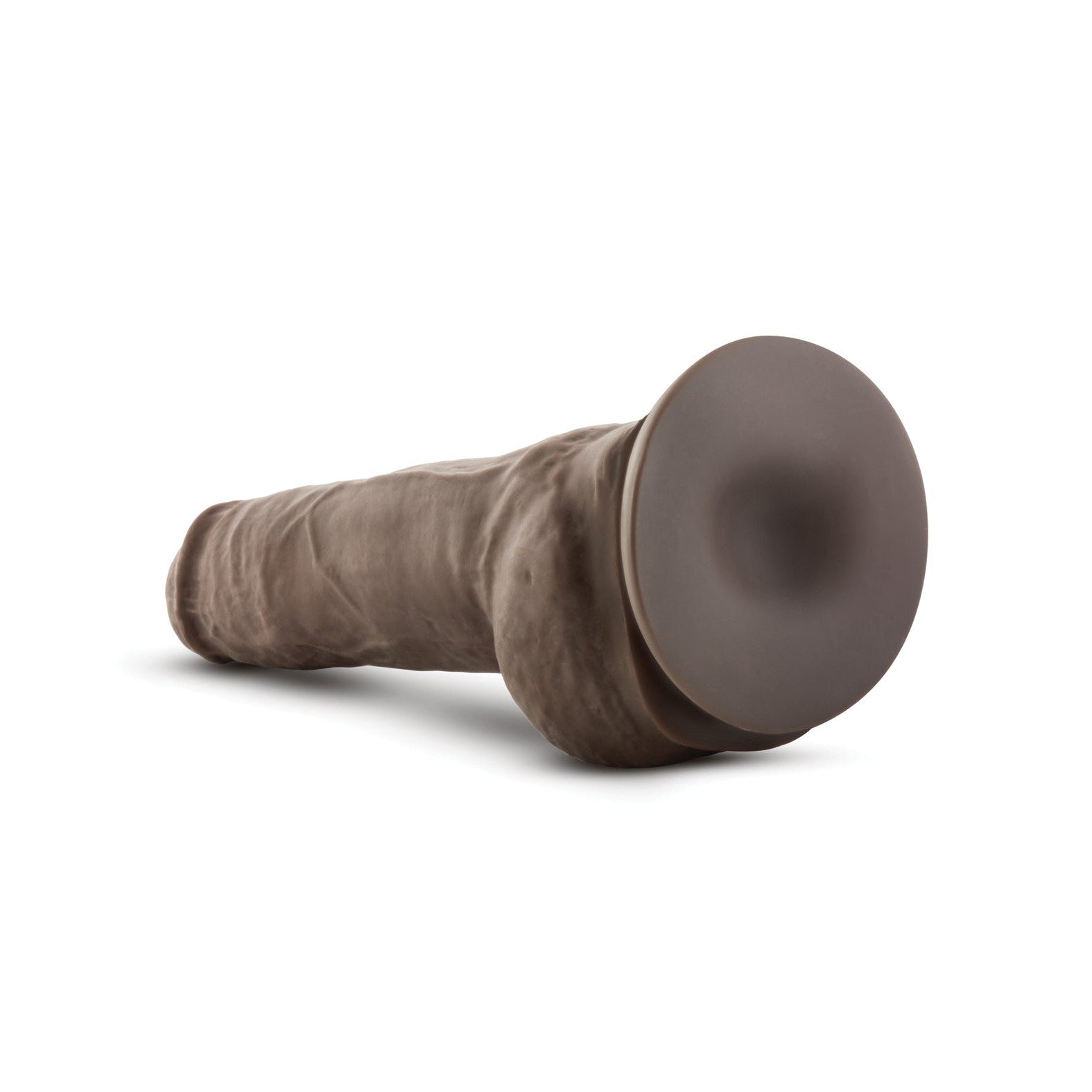 The Blush Au Naturel 10 Big Boy Realistic Dildo by Blush Novelties is displayed on a white background, featuring a brown silicone build with Dual Density for lifelike texture and a flat suction cup base.