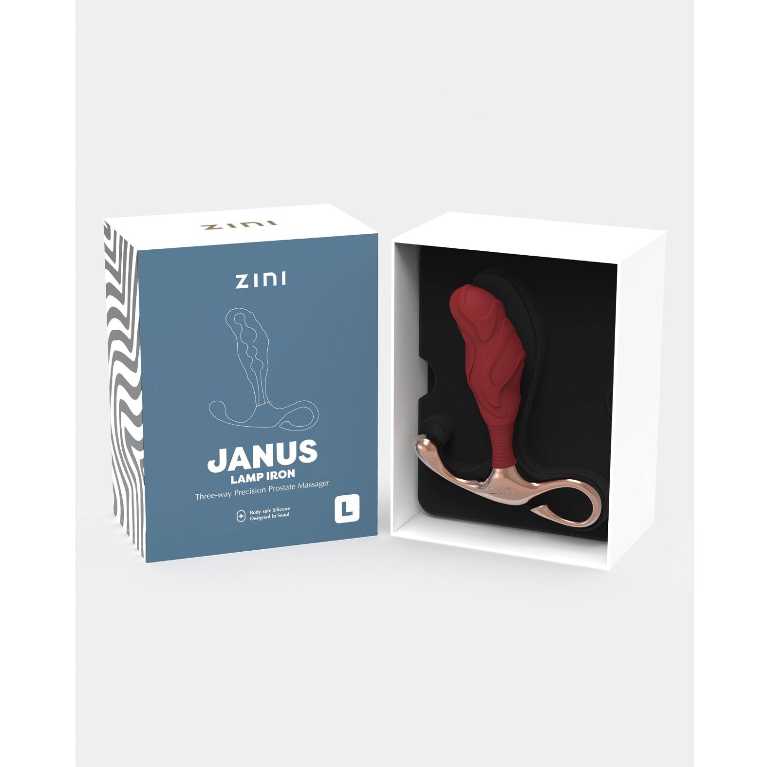 The Zini Janus Lamp Iron, a red and gold prostate massager made of body-safe silicone, is shown alongside its branded box featuring product imagery. Its ergonomically designed for optimal stimulation.