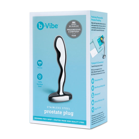 The image displays the packaging of the body-safe b-Vibe Stainless Steel Prostate Plug, featuring product details and promotional text that emphasize its temperature play capability, water resistance, and travel-size convenience.
