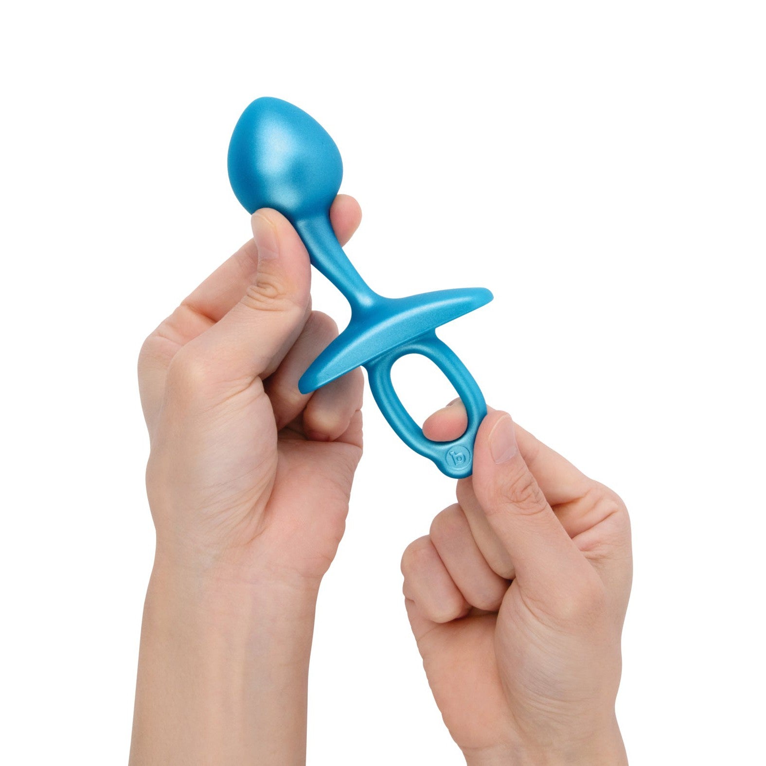 A blue silicone prostate plug, the b-Vibe Butties Bulb Tapered Prostate Plug by b-vibe, is held in hands. It has a tapered tip, a wide base, and a loop for easy use. Designed for P-spot pleasure, its sleek design stands out against the white background.