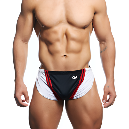 A muscular person wears Cover Male Running Shorts, characterized by a sleek black, white, and red design with CM emblazoned on the front. Against a plain white background, the soft and stretchy fit with contour pouch detail is showcased.