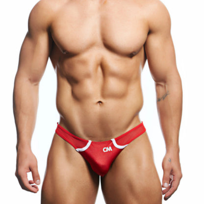 A muscular person embodies modern masculinity in red and white Cover Male Bikini for Men with Back Cut briefs. Featuring CM initials on the front, the premium fabric highlights their sculpted midsection and powerful thighs against a white background.