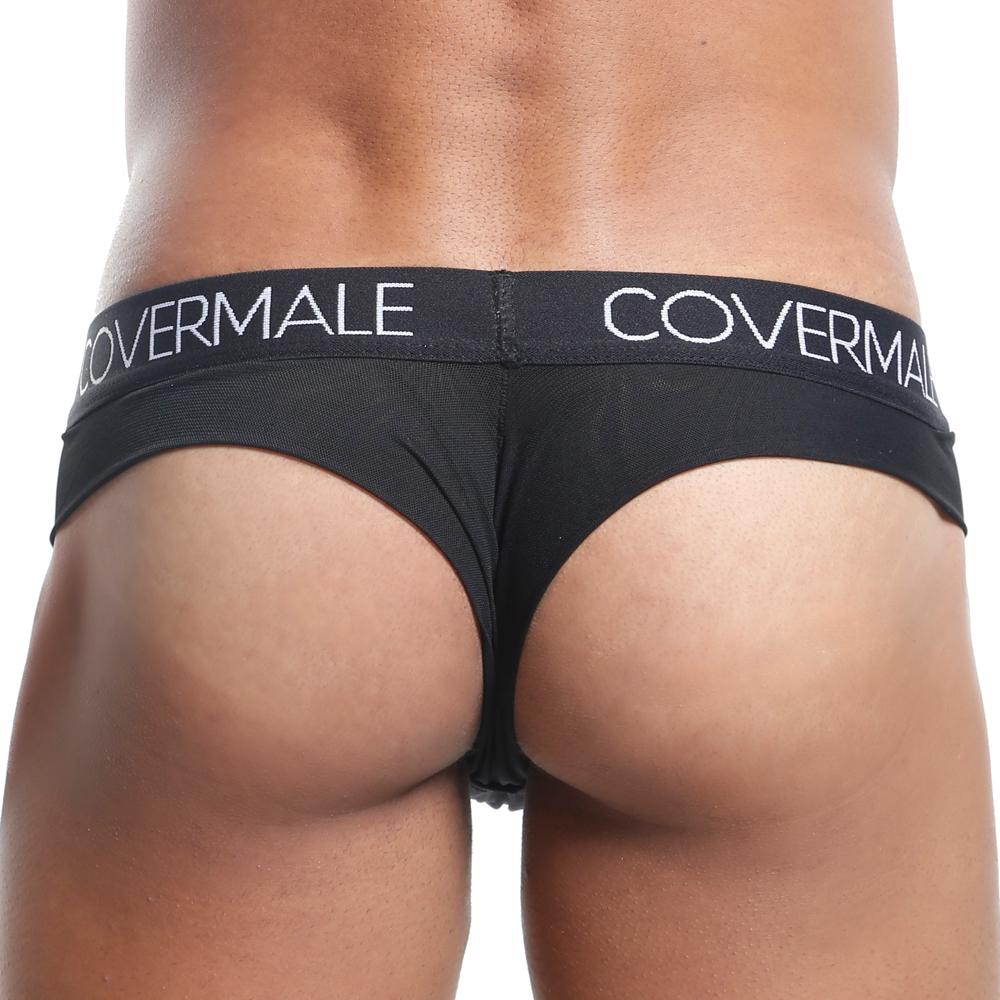 Someone wearing a chic Cover Male Slip Thong, offering cheeky coverage that enhances the lower back and upper thighs. The waistband proudly displays the brand name, Cover Male.