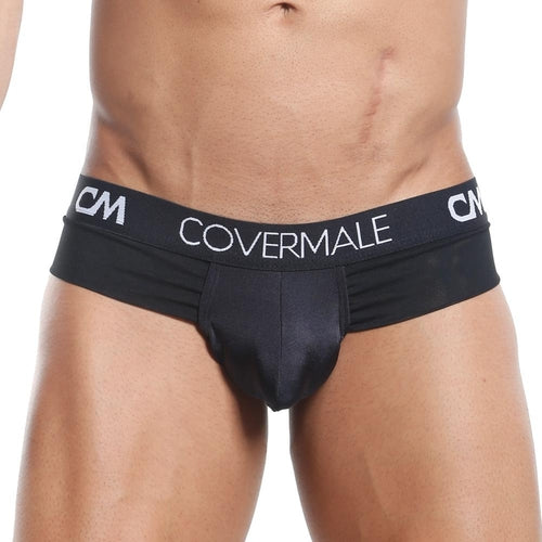 A model is shown from waist to above knees wearing sleek black Cover Male Slip Thong underwear. The stylish pouch and wide waistband adorned with CM initials offer cheeky coverage and impeccable fit, highlighting the fashionable design of this Cover Male piece.