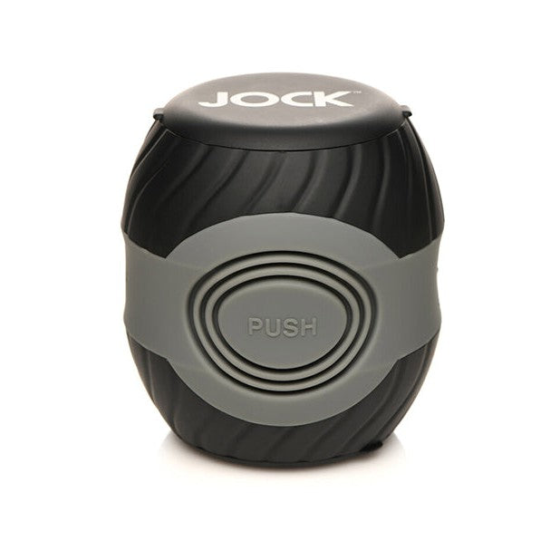 A black and gray cylindrical item labeled JOCK on top, the Curve Toys Jock 10x Vibrating Double Masturbator by Curve Novelties features a ribbed design and a PUSH button in the center, offering 10 vibration modes for enhanced experiences.