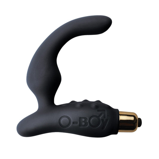 The Rocks Off O Boy 7, by Rocks Off, is a black curved personal massager with gold accents. Designed for prostate pleasure, it features a smooth texture and rounded handle with a small grip bump. O-BOY is inscribed on the handle. Its an ideal beginner prostate tool.