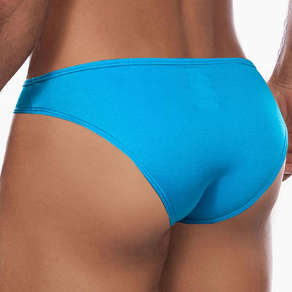 A person is photographed from the back wearing Daniel Alexander Colorful Slip bikini briefs by Daniel Alexander. The smooth, form-fitting fabric enhances the design and contoured pouch, while the plain white background highlights the briefs vibrant colors.