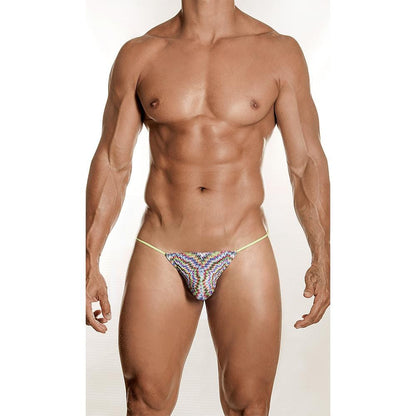A muscular man stands against a plain background, showcasing the Daniel Alexander Psychedelic Classic G-String with thin straps. This visually striking design from Daniel Alexander highlights his physique while the breathable fabric enhances both comfort and style.