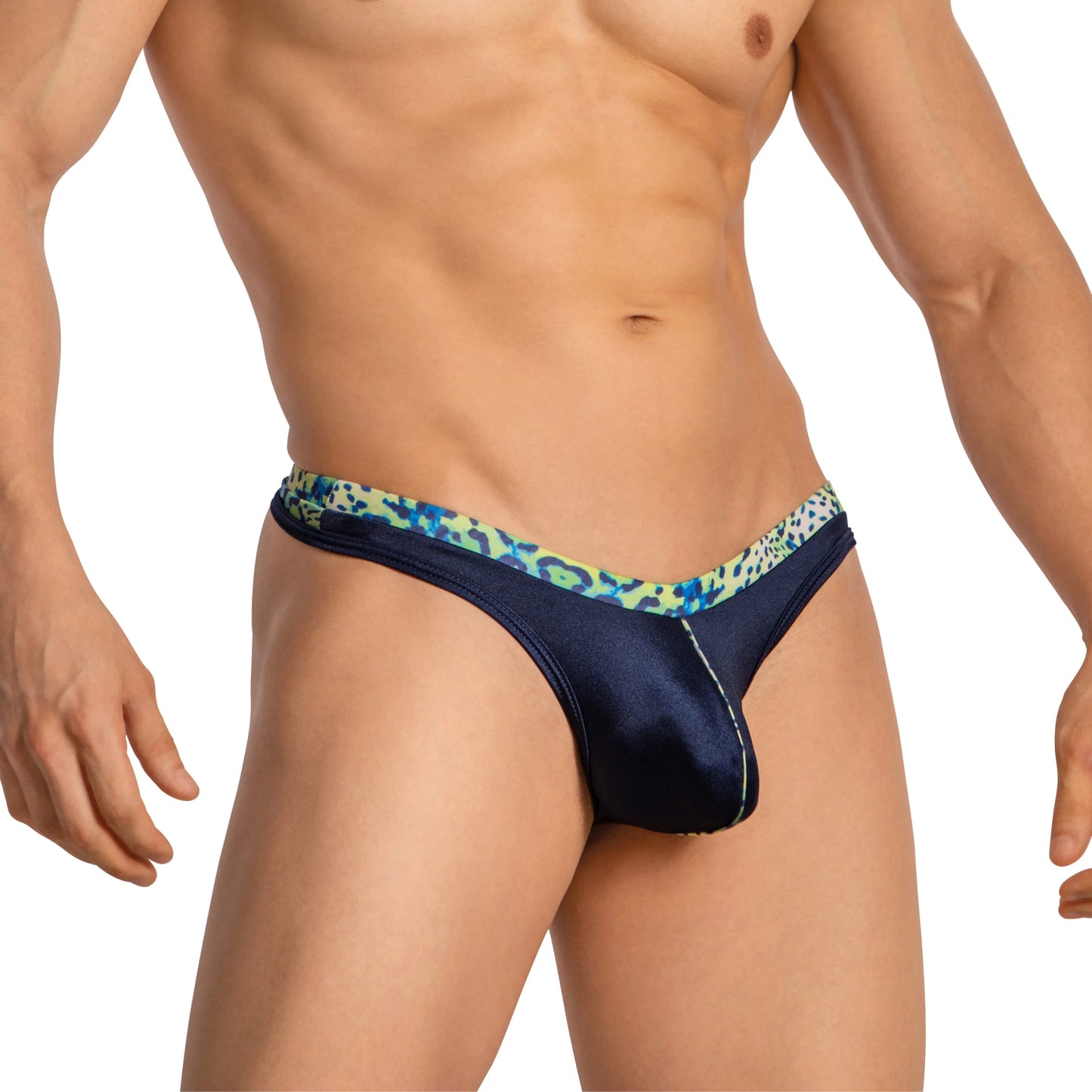 A confident individual wears Daniel Alexander Thongs with a leopard print. The plain white backdrop keeps focus on the style and fit, while their head is not visible in the image.