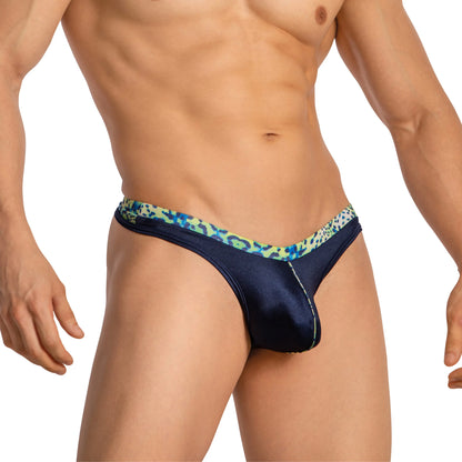 A confident individual wears Daniel Alexander Thongs with a leopard print. The plain white backdrop keeps focus on the style and fit, while their head is not visible in the image.