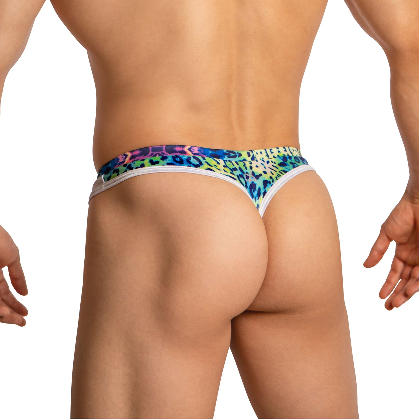 A man confidently models Daniel Alexander Thongs for Men with a colorful leopard print. The vibrant blue, green, purple, and pink patterns highlight his curves with second-skin comfort against a plain white background, focusing on the lower back and legs.
