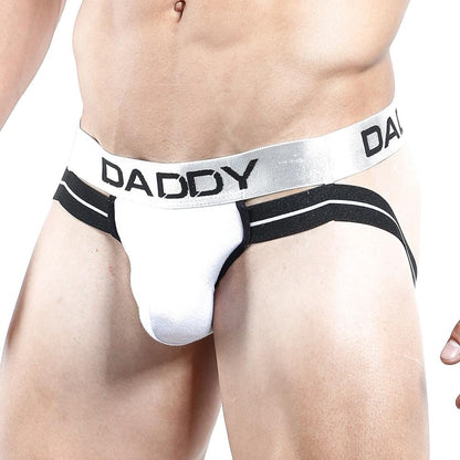 A close-up of a mans torso and upper thighs wearing the Daddy Jockstrap – Wear the Title, Own the Throne by Daddy, featuring a V-shaped pouch and DADDY boldly printed on its wide waistband.