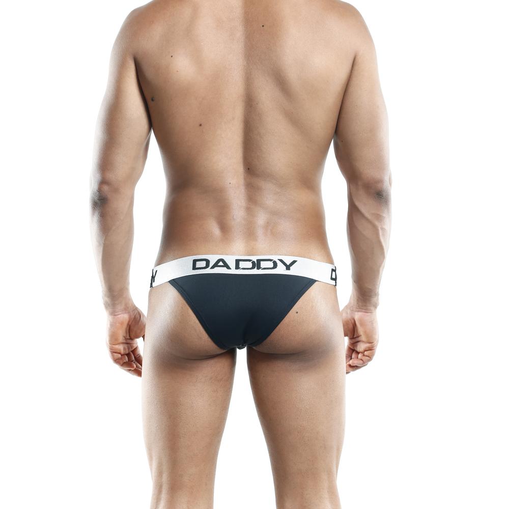 Rear view of a man wearing the Daddy Slip Bikini with DADDY on the waistband, featuring the sleek design against a white background.