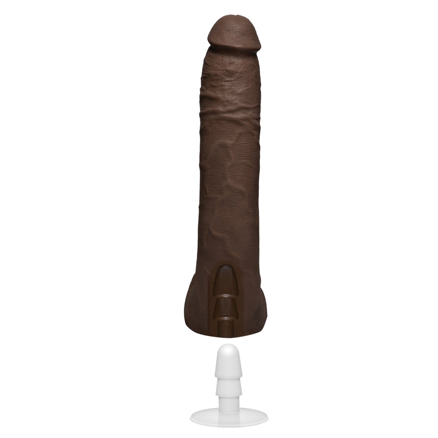 The Signature Cocks ULTRASKYN 10 by Doc Johnson is a dark brown, dual-density silicone sculpture resembling male genitalia, displayed upright on a white stand with a suction cup base.