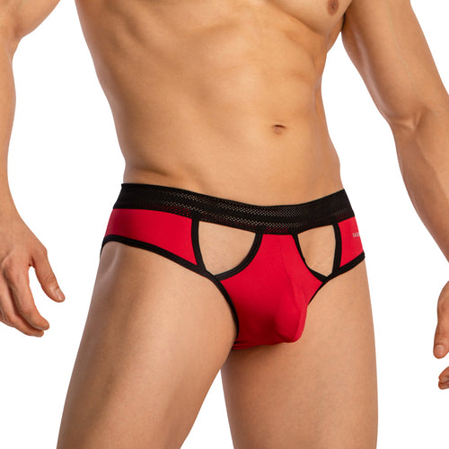 A muscular person models a red and black Daddy Revealing Stylish Jockstrap against a plain backdrop. Made from premium fabric, these mens underwear have a thick waistband with mesh details. The persons toned upper body is slightly visible.