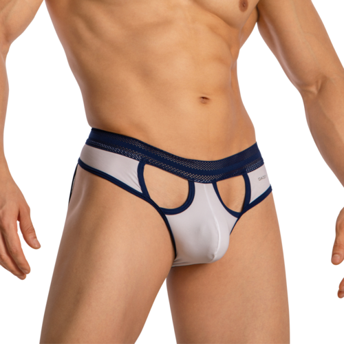 A person models the Daddy Revealing Stylish Jockstrap on a white backdrop, featuring a premium fabric blend. This mens underwear has mesh waistband detailing and cutout sections, presenting a modern design in navy blue and white.