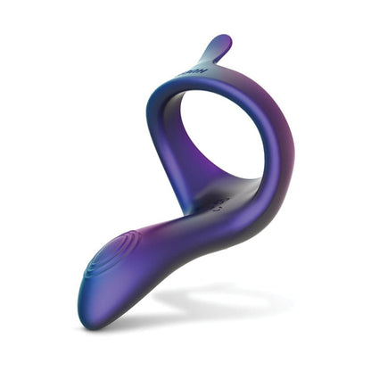 A silicone ring-shaped object in a purple and blue gradient with a small tab is likely the Hueman Solar Cock Ring with Vibrating Perineum by Hueman, featuring an ergonomic design for enhanced erections and possible USB rechargeability.