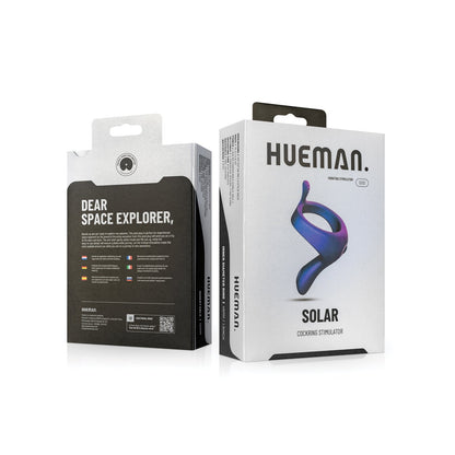 Two boxes of Hueman products are displayed. One box shows the Hueman Solar Cock Ring With Vibrating Perineum, a USB rechargeable device with a blue and purple ring to enhance erections. The other box invites space explorer and features colorful icons, highlighting benefits as a vibrating cock ring.