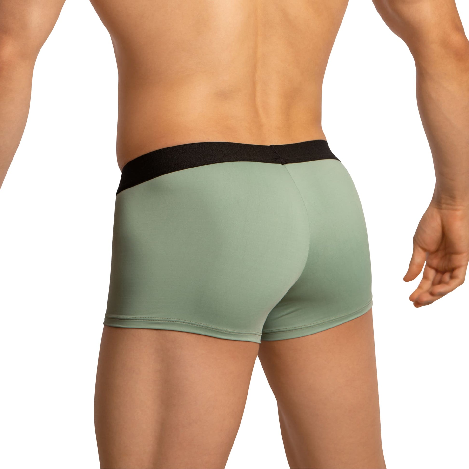 The image features a person in Edipous Mens Boxer Trunks, showcasing modern swagger with green trunks and a black waistband. They stand confidently against a plain white background.