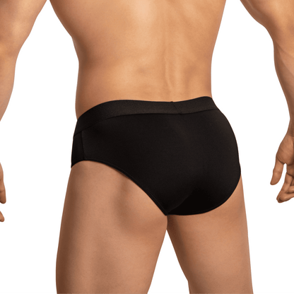 A person wearing Edipous Briefs for Men Open Front stands with their back turned, highlighting the seductive design and minimal coverage, emphasizing the fit and allure across the lower torso and upper legs.