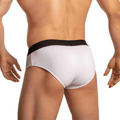 The image displays a person from the back wearing Edipous Briefs for Men Open Front, featuring minimal coverage white design with a black waistband, highlighting the seductive appeal of both the midsection and legs.