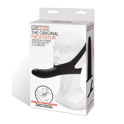 The box contains Lux Fetish The Original Facilitator by LUX, featuring a mannequin head with the black item and stretchy straps for a secure fit. This travel-friendly, chin-mounted dildo offers a hands-free design ideal for versatile oral use.
