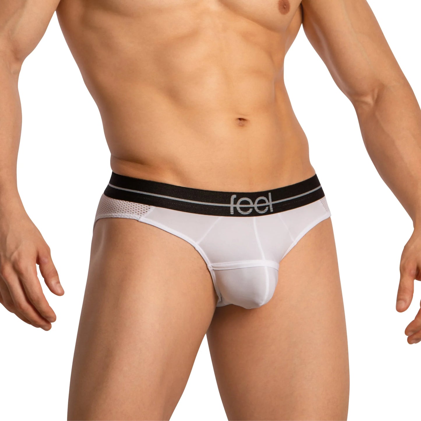 A male model showcases Feel Thongs for Guys from Feel, featuring a snug fit and sleek design. The white thongs with a black waistband branded with feel highlight both style and comfort while subtly emphasizing the elegance of his torso and upper legs.